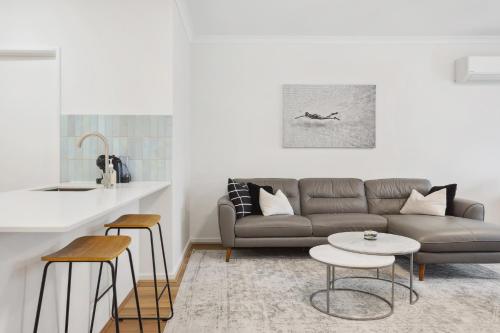 a living room with a couch and a table at REGL20/11 - East Perth Escape in Perth