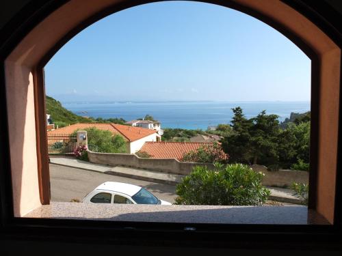 a house with a view of the ocean and mountains at La Finestra Vista Corsica in Santa Teresa Gallura