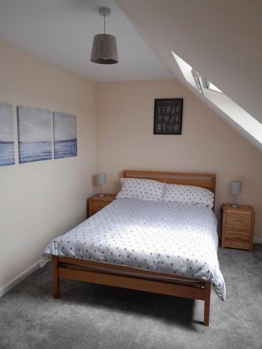 a bedroom with a bed in a white room at The Henge House in Salisbury