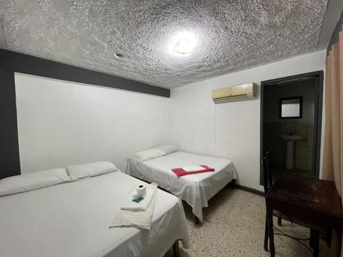 Postel nebo postele na pokoji v ubytování Hotel Central