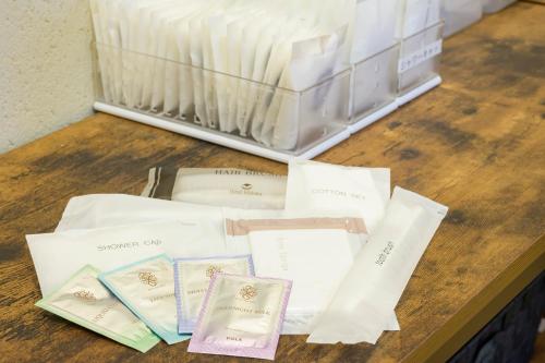 a table topped with white envelopes on top of a bed at Twin Leaves Hotel Izumo in Izumo
