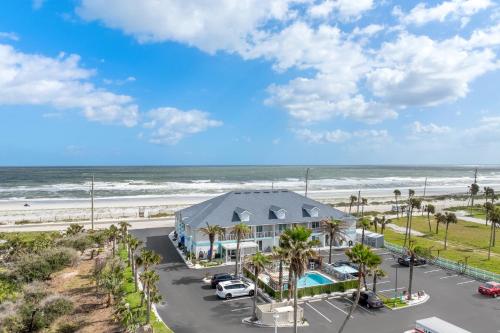 an aerial view of a building at the beach at Ocean Sands Beach Boutique Inn-1 Acre Private Beach-St Augustine Historic-2 Miles-Shuttle with Downtown Tour-HEATED Salt Water Pool until 420AM-Popcorn-Cookies-New 4k USD Black Beds- 69 Item Breakfast-Eggs-Bacon-Starbucks- Free Laundry- #904-799-SAND in Saint Augustine