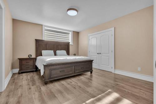 a bedroom with a large bed and a window at Private Farmhouse Getaway with hot tub in Waterloo