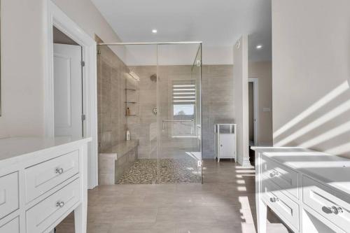 a large white bathroom with a shower and a tub at Private Farmhouse Getaway with hot tub in Waterloo