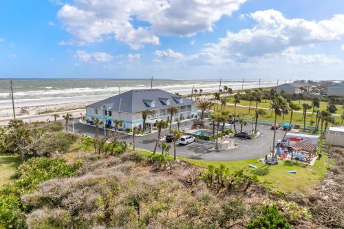 an aerial view of a house next to the beach at Ocean Sands Beach Boutique Inn-1 Acre Private Beach-St Augustine Historic-2 Miles-Shuttle with Downtown Tour-HEATED Salt Water Pool until 420AM-Popcorn-Cookies-New 4k USD Black Beds- 69 Item Breakfast-Eggs-Bacon-Starbucks- Free Laundry- #904-799-SAND in Saint Augustine