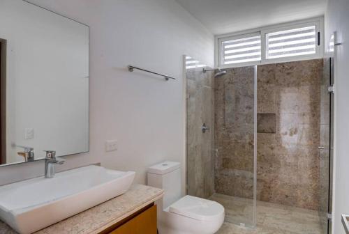 ein Badezimmer mit Waschbecken, Dusche und Toilette in der Unterkunft Penthouse with Beach Acces and Golf course in Akumal