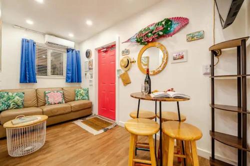 a living room with a couch and a red door at Stunning Little Havana Suites Close to airport, Calle Ocho, Brickell, Wynwood and the Beaches - Free Parking in Miami