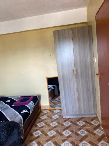 Postel nebo postele na pokoji v ubytování Tsavo Apartments Ogembo