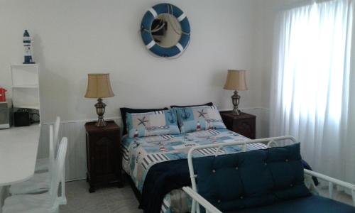 a bedroom with a bed and a mirror on the wall at Jetty Self-Catering in Swakopmund