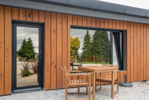 a wooden building with a wooden table and chairs at TerraSena Mountain Village in Seia