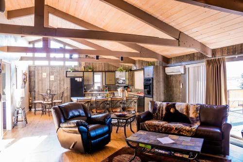 a living room with two couches and a kitchen at Murphy's Resort in Estes Park