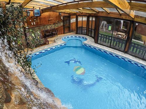 a large swimming pool in a building with at Cabañas Antuken - Piscina Cubierta - in San Martín de los Andes
