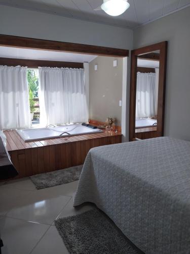 Postel nebo postele na pokoji v ubytování Chalé Recanto do Pimenta e Casa Recanto do Pimenta