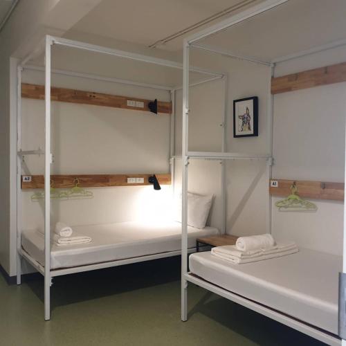 a couple of bunk beds in a room at Hello my friend in Bang Bua Thong Railway Station