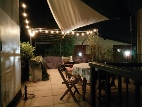 a patio with a table and chairs and lights at Villa San Cataldo primo piano in Modena