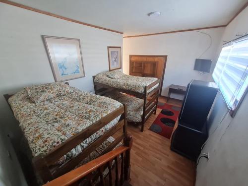 an overhead view of a bedroom with two beds and a window at NEW HOTEL CRUZ DEL SUR in Concepción