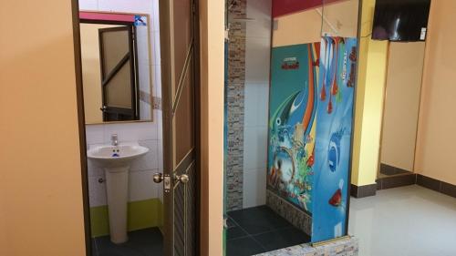 a bathroom with a sink and a shower door at Hotel Platinum Class in Nueva Loja