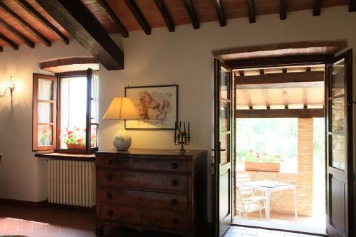 a living room with a dresser and a sliding glass door at Agriturismo Podere Luchiano in Amelia
