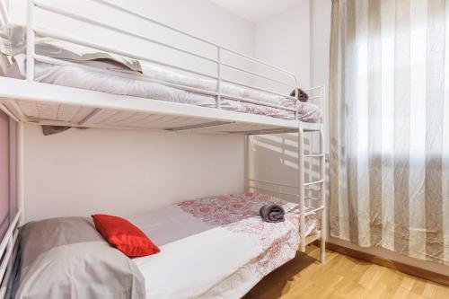 a small bedroom with two bunk beds in it at Matarolux 1 in Mataró