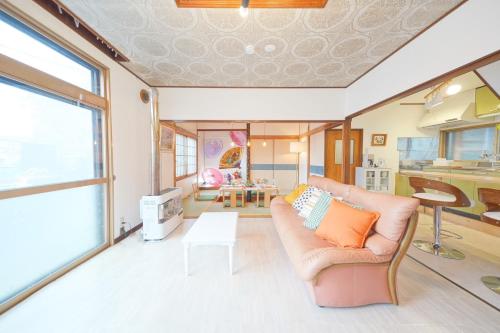 a living room with a couch and a table at 小樽運河まで徒歩7分 小樽のノスタルジックな戸建貸切 Tabiyado in Otaru