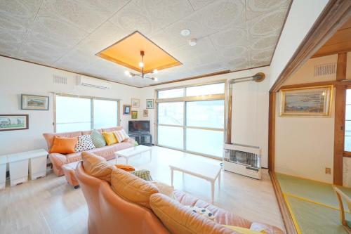 a living room with two couches and a fireplace at 小樽運河まで徒歩7分 小樽のノスタルジックな戸建貸切 Tabiyado in Otaru
