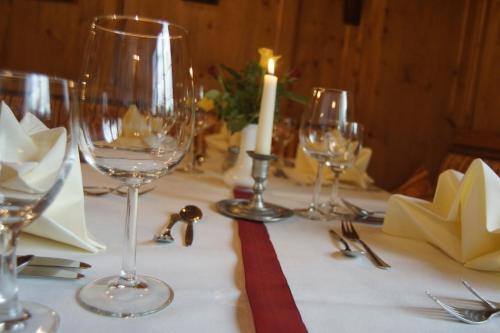 a table with wine glasses and a candle on it at Tutzinger Hof in Tutzing