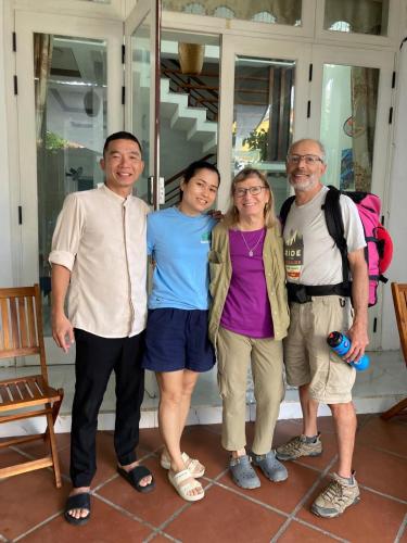 a group of people posing for a picture on a porch at Good Morning Hoi An Homestay and Hostel in Hoi An