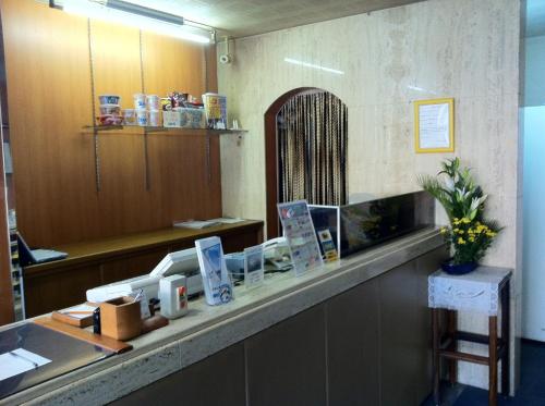 ein Wartezimmer mit einer Theke und einem Spiegel in der Unterkunft Prince Hotel Shimonoseki in Shimonoseki