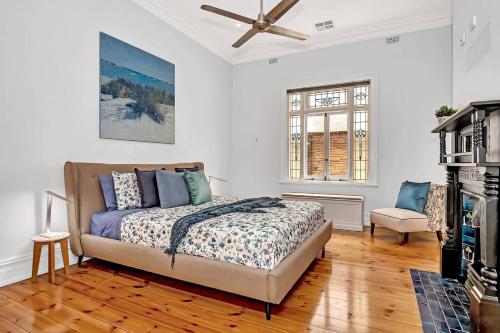 a bedroom with a bed and a ceiling fan at Birdy Beach House - An Idyllic Oceanfront Lifestyle in Grange