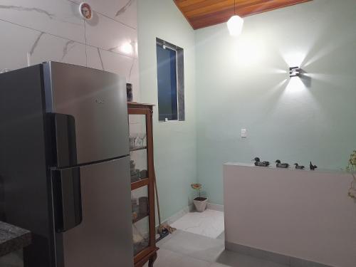 eine Küche mit einem Kühlschrank aus Edelstahl in einem Zimmer in der Unterkunft Chalé Verde Mar em São Sebastião in São Sebastião