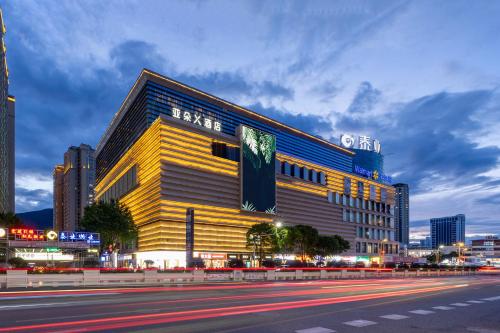 a large yellow building on a city street at night at Atour Hotel Dali Xiaguan Taiye International Plaza in Dali