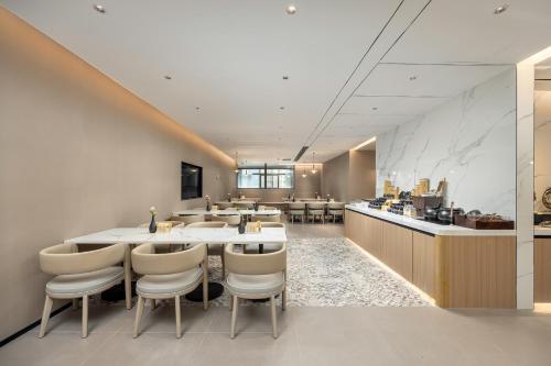 a restaurant with a table and chairs and a counter at Atour Hotel Dali Xiaguan Taiye International Plaza in Dali