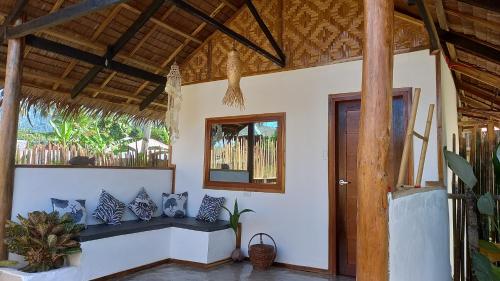 a living room with a bench and a mirror at Valerie Lodge in San Vicente