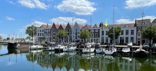 a group of boats are docked in a harbor at Logeren aan de Haven - Appartement Spijkerbrug in Middelburg