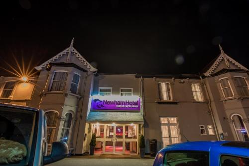 a building with a sign on the front of it at Newham Hotel in London