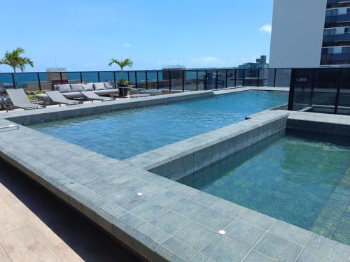 a swimming pool on the roof of a building at WAY Tambáu - Pé na Areia in João Pessoa
