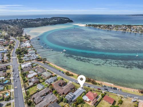 an aerial view of a beach and the ocean at 15 Beach St in Merimbula