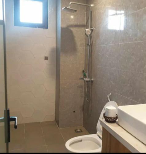 a bathroom with a shower with a toilet and a sink at Camy's House in An Bàn (2)