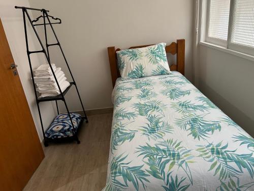 a bedroom with a bed with a pillow and a ladder at Novíssimo apt 1 quarto Centro frente à Prefeitura in Nova Friburgo