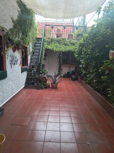 a patio with a staircase in a building with plants at La suite más cómoda y elegante in Mexico City