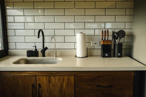 a kitchen counter with a sink and utensils at Refined cabin, panoramic views, steps from Jericó in Jericó