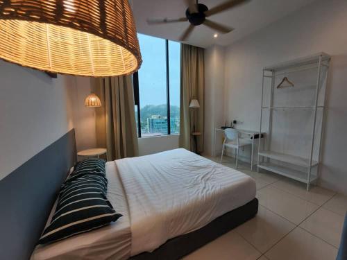 a bedroom with a bed and a large window at ITCC Manhattan Suites by Kansayan Homestay in Penampang