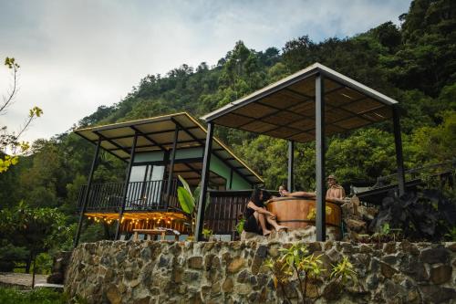 a group of people sitting outside of a house at Refined cabin, panoramic views, steps from Jericó in Jericó