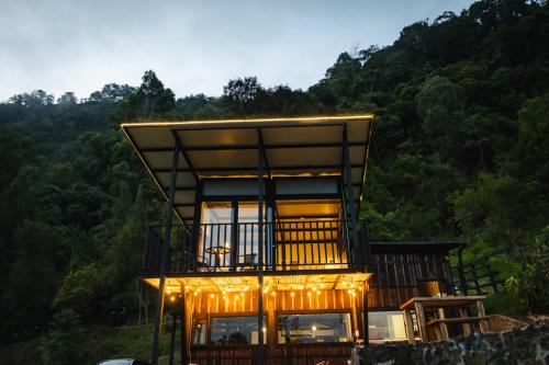 a tree house with lights on top of it at Refined cabin, panoramic views, steps from Jericó in Jericó