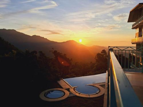 a view of the sunset from the balcony of a building at Moi Ella by DBI in Ella