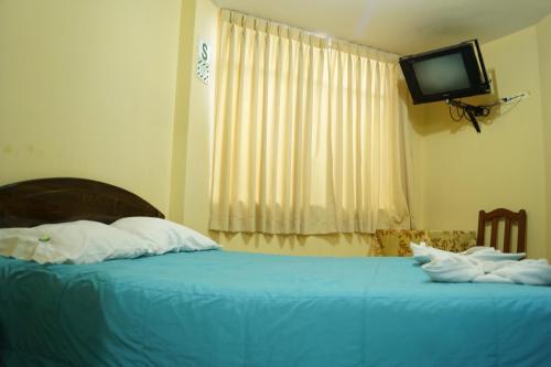 Tempat tidur dalam kamar di Hotel Los Gladiolos
