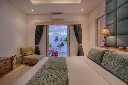 a bedroom with a bed and a chair and a window at Saba Villa by Sanga Sanga Hospitality in Saba