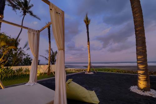 a room with a bed with a view of the ocean at Saba Villa by Sanga Sanga Hospitality in Saba