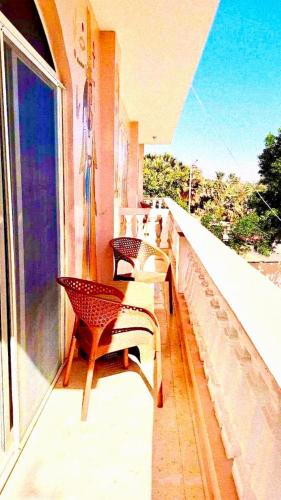 a balcony with chairs and a view of the ocean at MAGIC GUEST HOUSE - Δ Relax Pur Δ 15 MiN TO ASWAN in Aswan