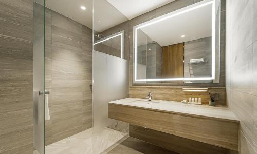 a bathroom with a sink and a mirror at The May Hotel in Jeonju